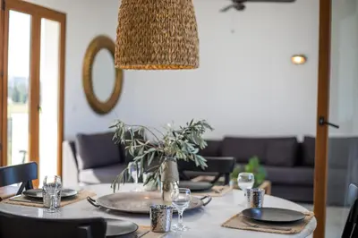 a dining room table with plates and glasses on it at Villa Kora in Kallithea Rhodes