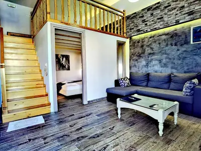 a living room with a couch and a table at Vlycha Beach Apartments in Líndos