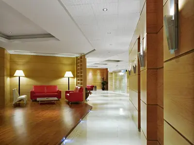 a lobby with red chairs and a waiting room at Athineon Hotel in Rhodes Town