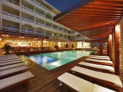 a swimming pool with lounge chairs in a hotel at Athineon Hotel in Rhodes Town