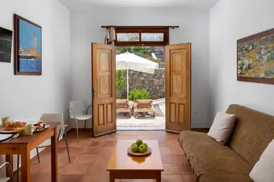 a living room with a couch and a table at George's Villas in Líndos