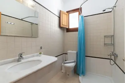 a bathroom with a tub and a toilet and a sink at George's Villas in Líndos
