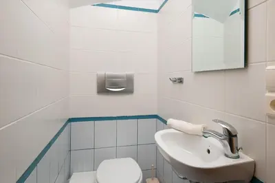 a bathroom with a sink and a toilet at George's Villas in Líndos