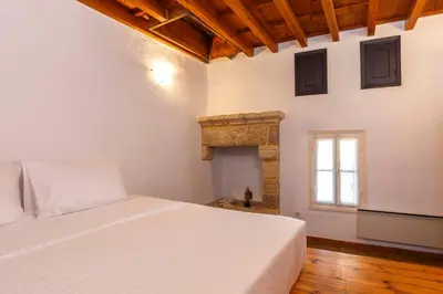 a bedroom with a white bed and a window at Belvedere Medieval Villa in Rhodes Town