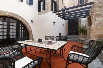 a table and chairs sitting on a patio at Belvedere Medieval Villa in Rhodes Town