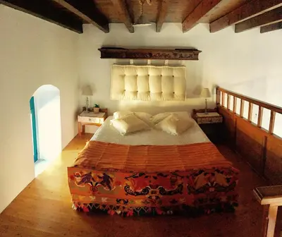 a bedroom with a large bed in a room at Mariza's traditional house 1900 in Soroni