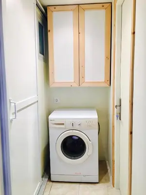 a washer and dryer in a small room at Mariza's traditional house 1900 in Soroni