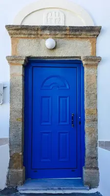 a blue door in front of a building at Mariza's traditional house 1900 in Soroni