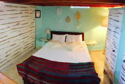 a bedroom with a large bed in a room at Mariza's traditional house 1900 in Soroni