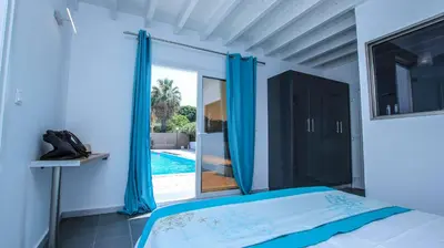 a bedroom with a bed and a view of a swimming pool at Villa Elpiniki in Ixia