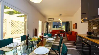 a kitchen and dining room with a table and chairs at Villa Elpiniki in Ixia