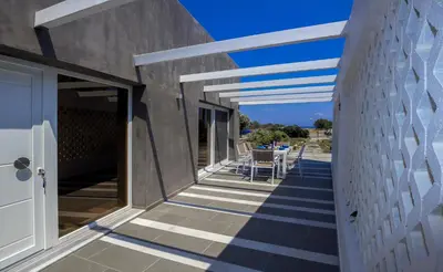 a walkway leading to the patio of a house at Villa Elpiniki in Ixia