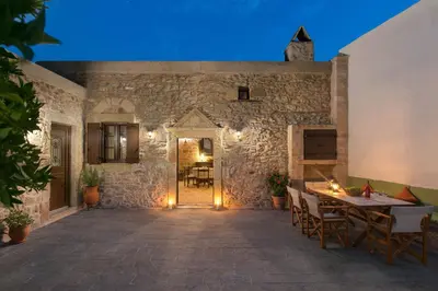 an entrance to a stone building with a table and chairs at Rodia House in Lardos