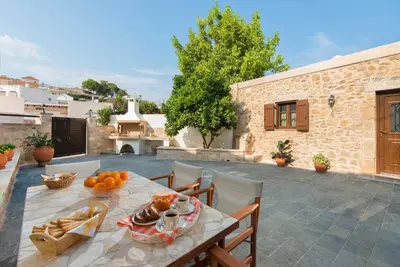 a patio with a table with food on it at Rodia House in Lardos