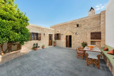an outdoor patio with a table and chairs at Rodia House in Lardos