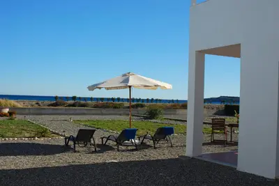 a group of chairs and an umbrella in a yard at Villa Mangano in Afantou