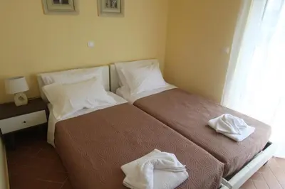 a bedroom with two beds with towels on them at Villa Mangano in Afantou