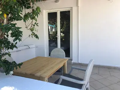 a wooden table and chairs on a patio at Sotiris rooms in Faliraki