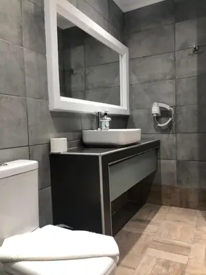 a bathroom with a sink and a mirror at Sotiris rooms in Faliraki