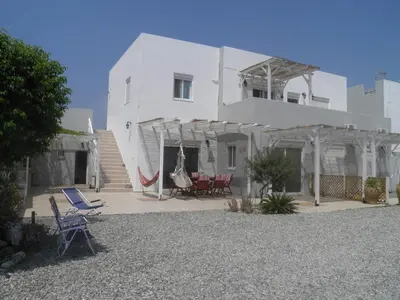 a white house with chairs and a patio at Sea House Lahania in Lachania