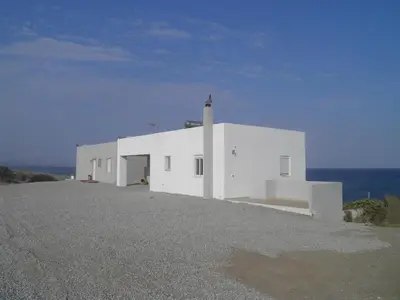 a white building on top of a hill with the ocean at Sea House Lahania in Lachania