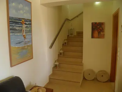 a stairway with a painting of a woman on the beach at Sea House Lahania in Lachania