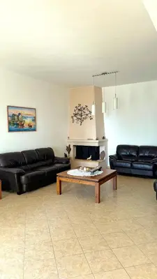 a living room with black leather couches and a coffee table at Sea House Lahania in Lachania