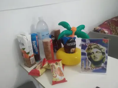 a table with a toy duck and other items on it at Apollon Apartments H-3 H-4 in Rhodes Town