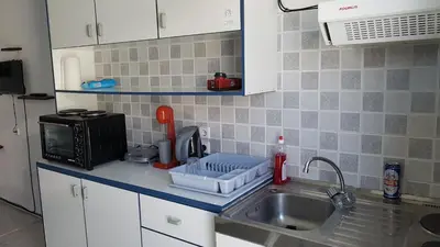 a kitchen counter with a sink and a microwave at Apollon Apartments H-3 H-4 in Rhodes Town