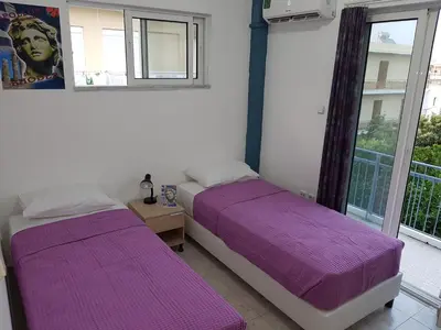 two beds in a room with purple sheets at Apollon Apartments H-3 H-4 in Rhodes Town