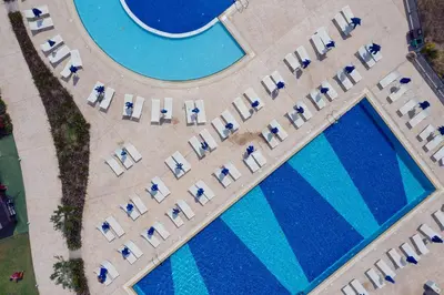 an overhead view of a pool with chairs and lounges at Princess Sun Hotel in Kiotari