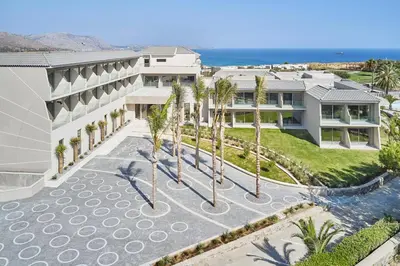 an aerial view of a building with palm trees at Princess Sun Hotel in Kiotari