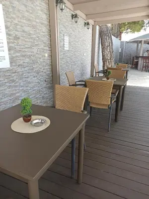 a row of tables and chairs on a deck at Summer Dream in Theologos