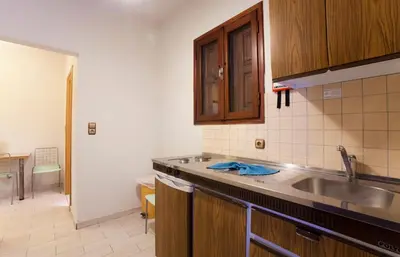 a kitchen with a sink and a counter top at Pefkos Beach Studios & Apartments in Pefki Rhodes