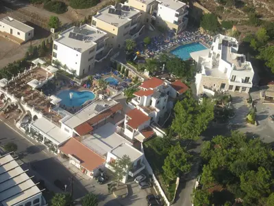 an aerial view of a resort with a pool at Pefkos Beach Studios & Apartments in Pefki Rhodes