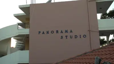 a sign for panoramic studio on the side of a building at Panorama Studios in Faliraki