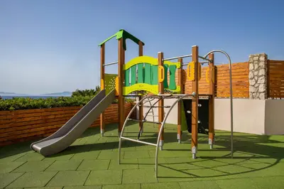 a playground with a slide on a patio at Sol Cosmopolitan Rhodes in Ixia