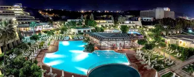an overhead view of a large swimming pool at night at Sol Cosmopolitan Rhodes in Ixia