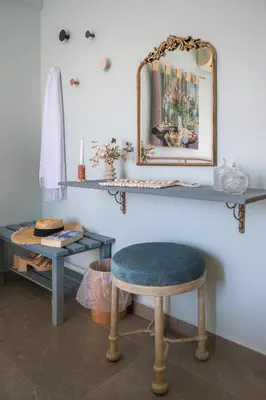 a dressing room with a stool and a mirror at Rosmari Hotel in Archangelos