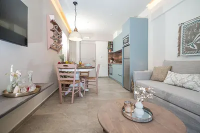 a living room with a couch and a table at Rosmari Hotel in Archangelos