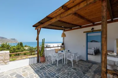 a villa with a view of the ocean at Agnanti Beach Apartments in Archangelos