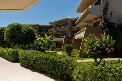 a building with bushes in front of a building at Cathrin Hotel in Faliraki