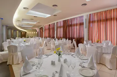 a banquet hall with white tables and chairs at Virginia Family Resort in Kallithea Rhodes