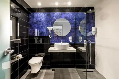 a bathroom with a toilet and a sink and a mirror at Virginia Family Resort in Kallithea Rhodes