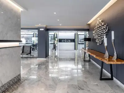 an office lobby with a view of an alia sign on the wall at Mercure Rhodes Alexia Hotel & Spa in Rhodes Town