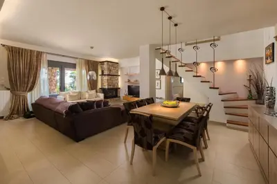 a living room and dining room with a couch and a table at Blue & Green View Villa in Asgourou