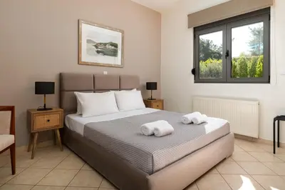a bedroom with a bed with towels on it at Blue & Green View Villa in Asgourou