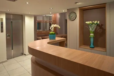a lobby with a reception desk with a vase of flowers at Hotel Hermes in Rhodes Town