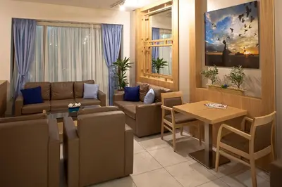 a living room with a couch and a table at Hotel Hermes in Rhodes Town