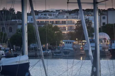 a group of boats docked in a marina at night at Hotel Hermes in Rhodes Town